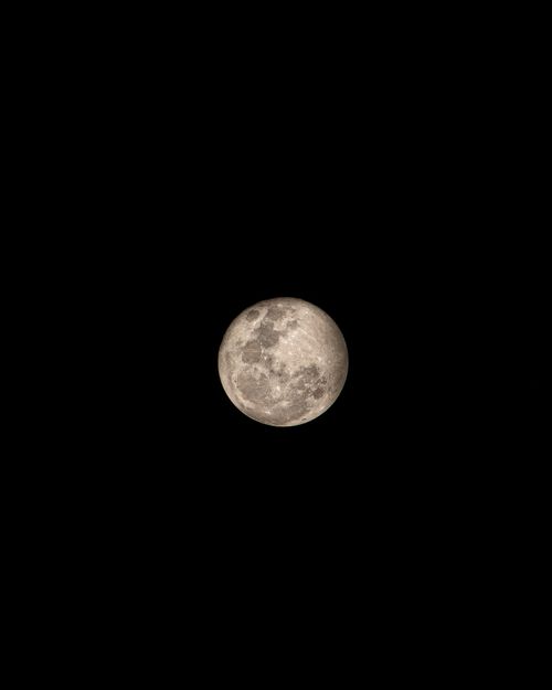 Free Captivating view of a full moon shining brightly against the dark night sky. Stock Photo