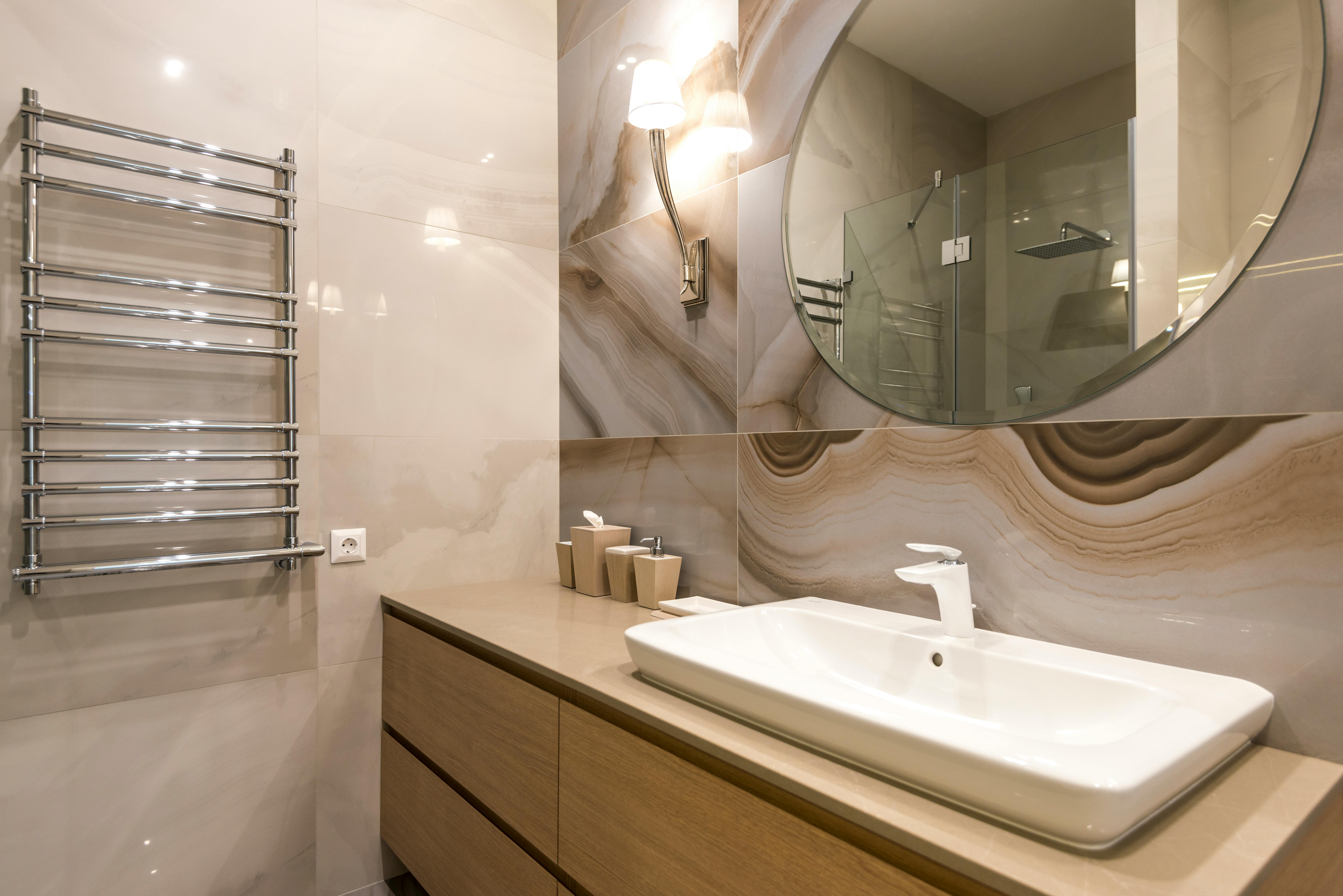 Clean bathroom surfaces including tile, glass, and chrome.