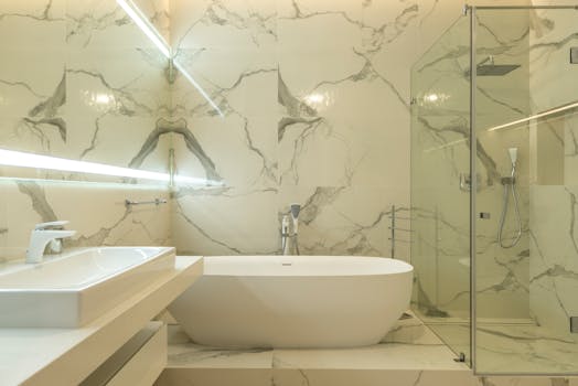Elegant marble bathroom featuring a bathtub, sink, and glass shower enclosure.