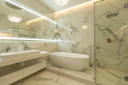 Elegant marble bathroom with bathtub, sink, and glass shower enclosure.
