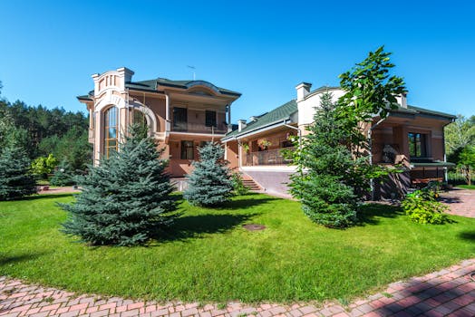 Elegant suburban estate with modern architecture amidst lush greenery, captured on a sunny day.