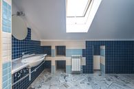 Comfort Room Interior Design with White Ceramic Sink and Tiled Walls