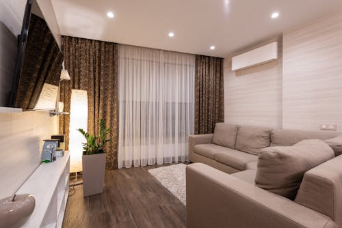 Living Room Interior Design with Beige Sectional Couch Beside Brown and White Window Curtain