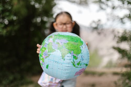 A Girl Holding a Globe