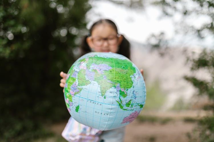 A Girl Holding A Globe