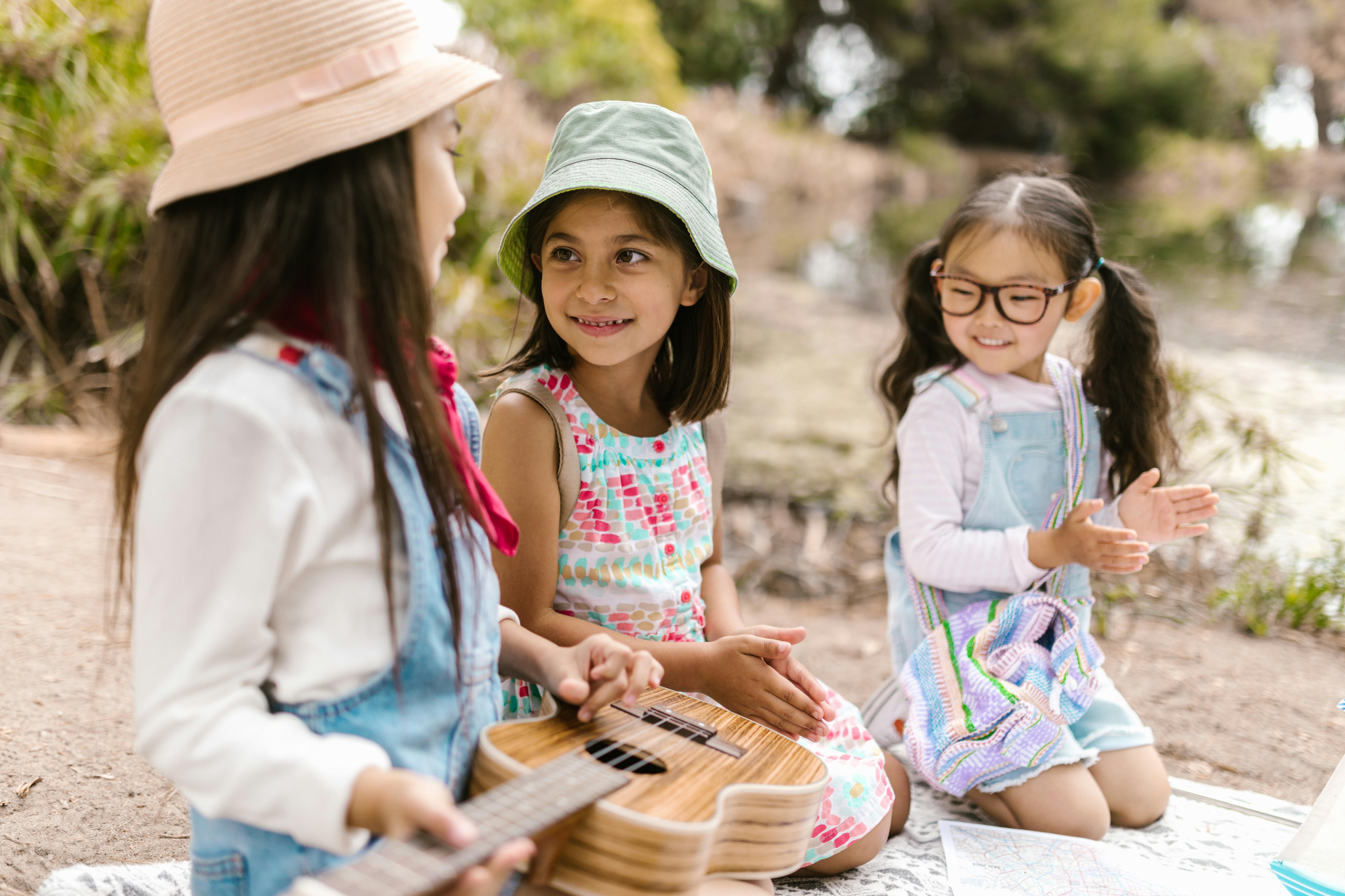 girls kneeling on a picnic blanket together