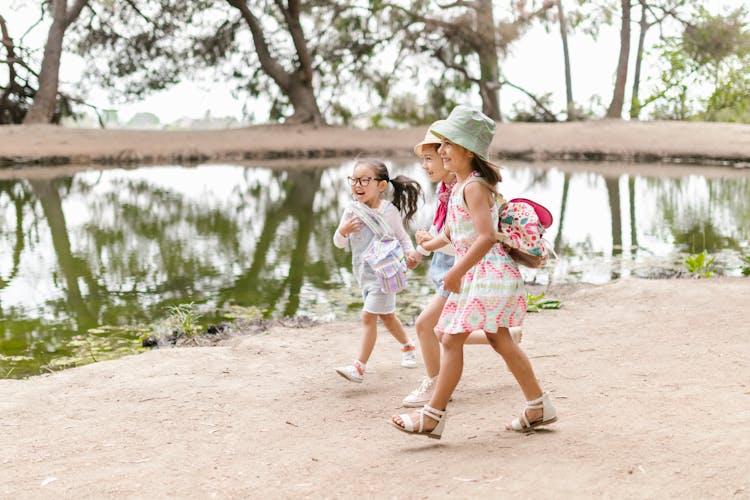 3 Girls Walking Near Body Of Water