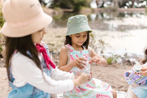 Free Girls in Panama Hats Playing Tea Party Stock Photo