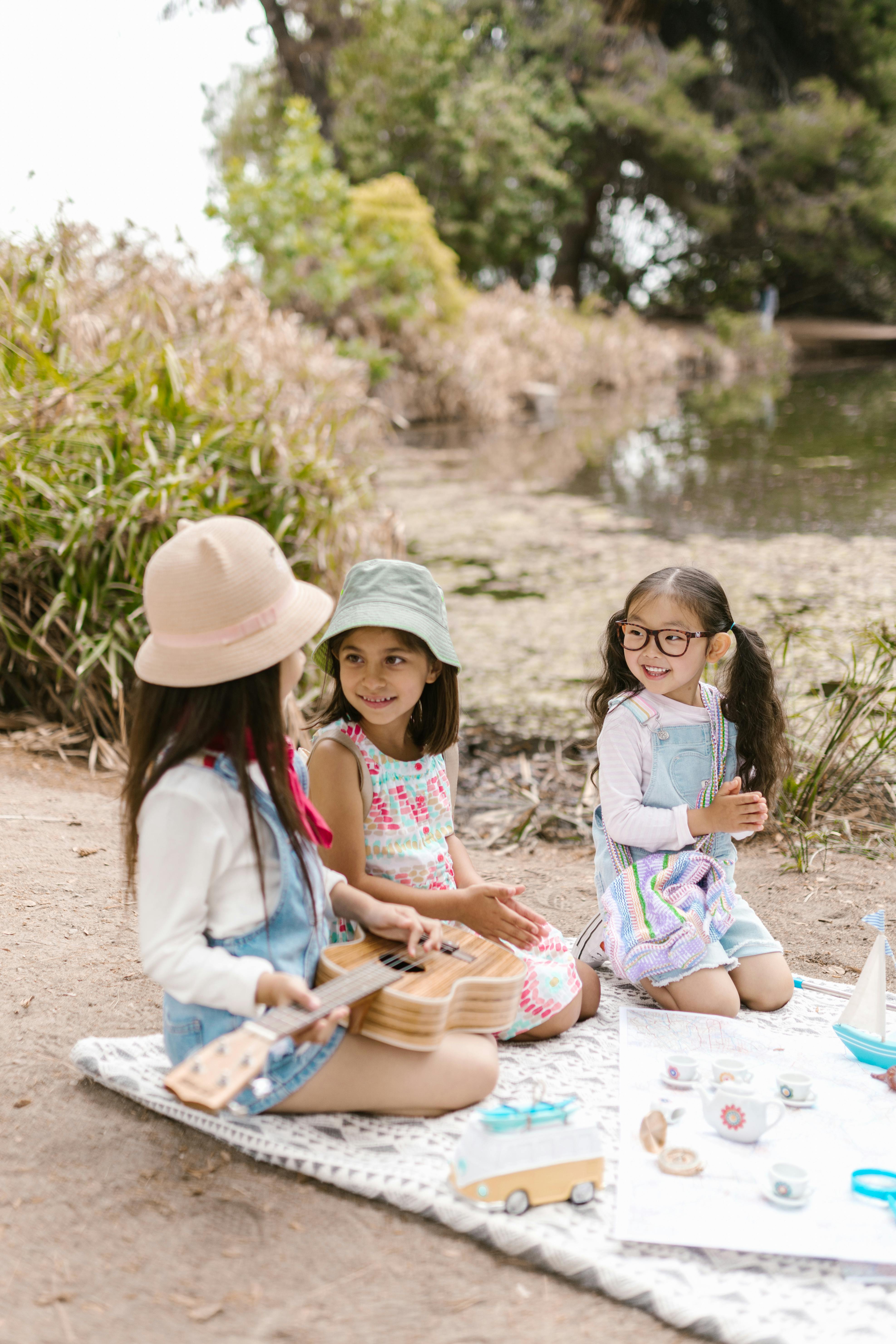 3 girls playing on picnic blanket