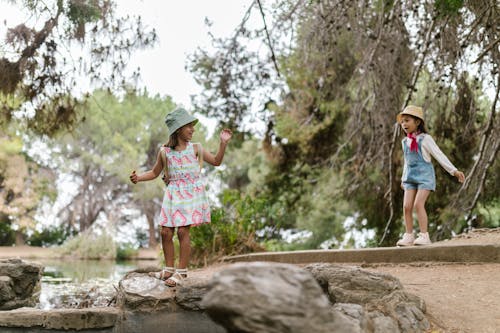 Free 2 Girls in Panama Hats Playing in Park Stock Photo