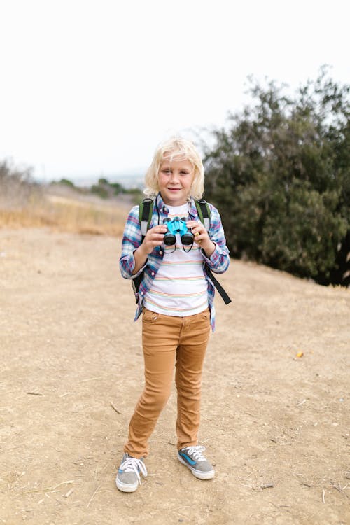 A Boy Holding Binoculars