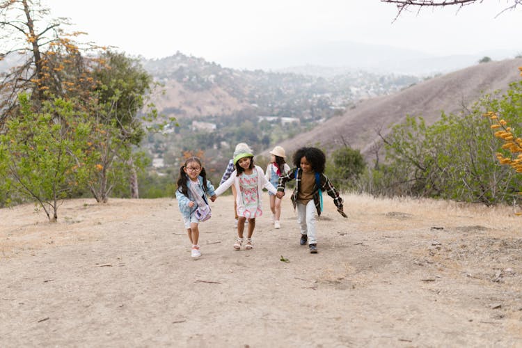 A Group Of Kids Running Together