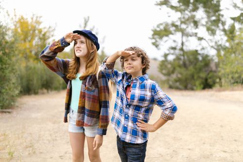 Free Two children in plaid shirts gaze into the distance outdoors, embodying exploration and adventure. Stock Photo