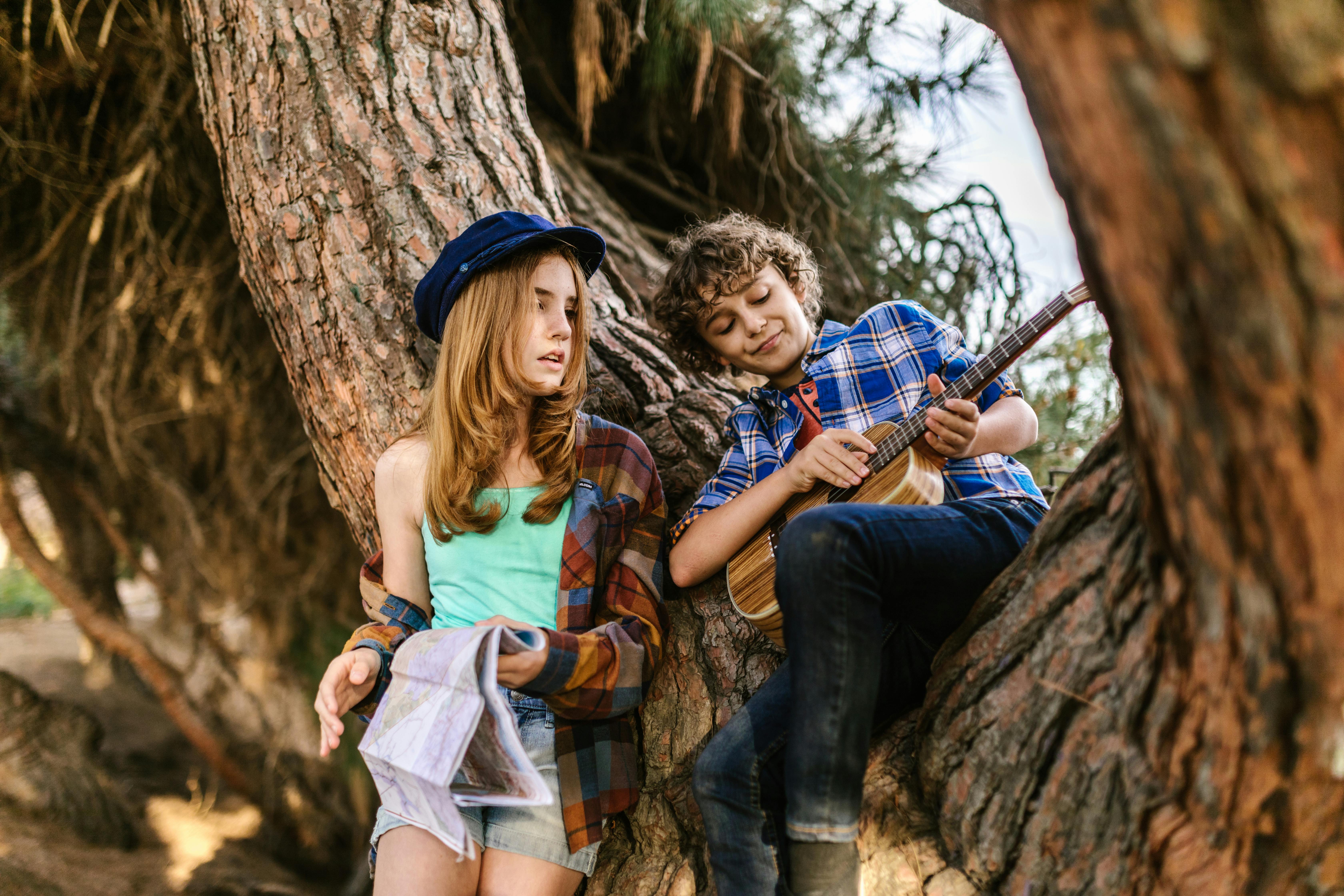 a boy and girl on the tree together