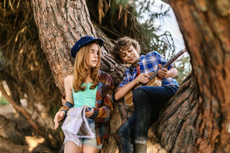 A Boy And Girl On The Tree Together 