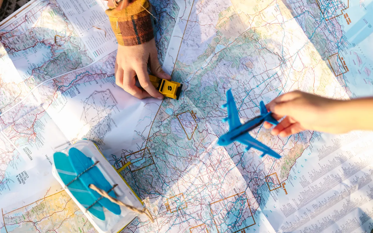 Toy vehicles on a map for journey planning