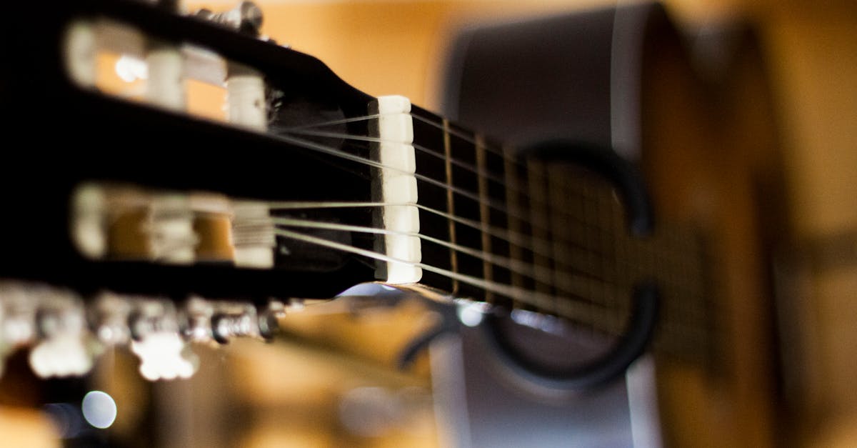 Selective Focus Photo of Black Classical Guitar