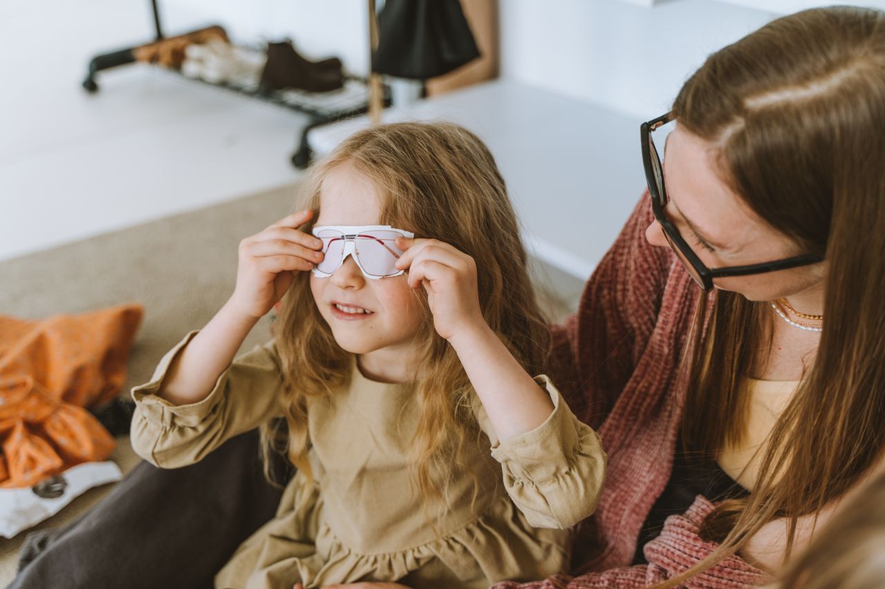 a mother and daughter share a joyful moment indoors emphasizing love a