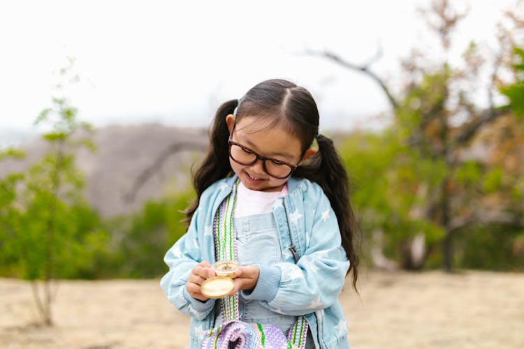 Photo Of A Child Holding A Compass