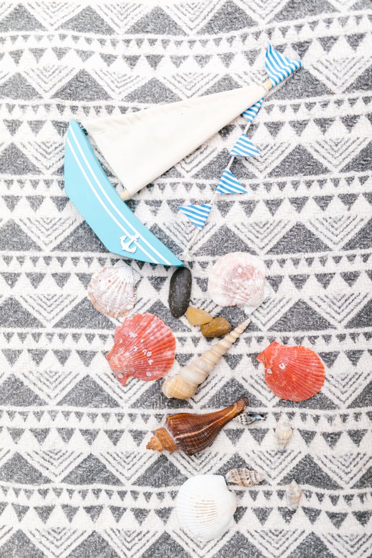 Blue And White Boat And Seashells On Textile With Geometric Pattern