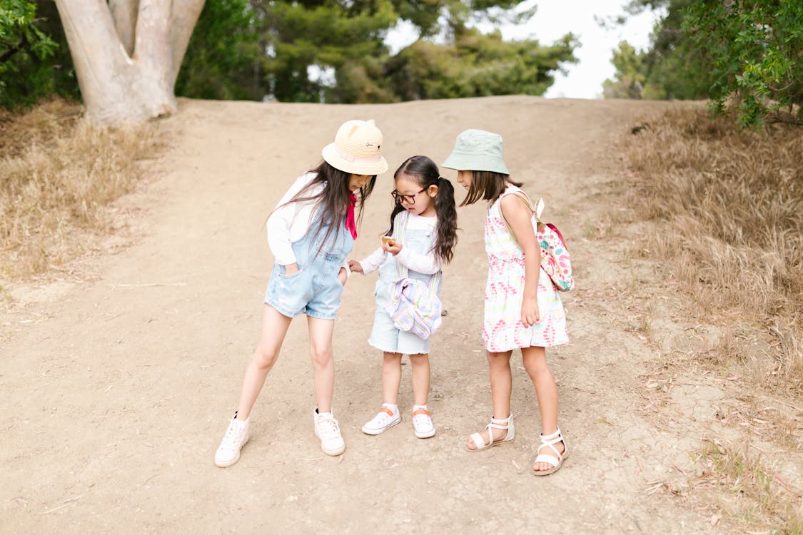 Free Three Children Looking at an Object Stock Photo