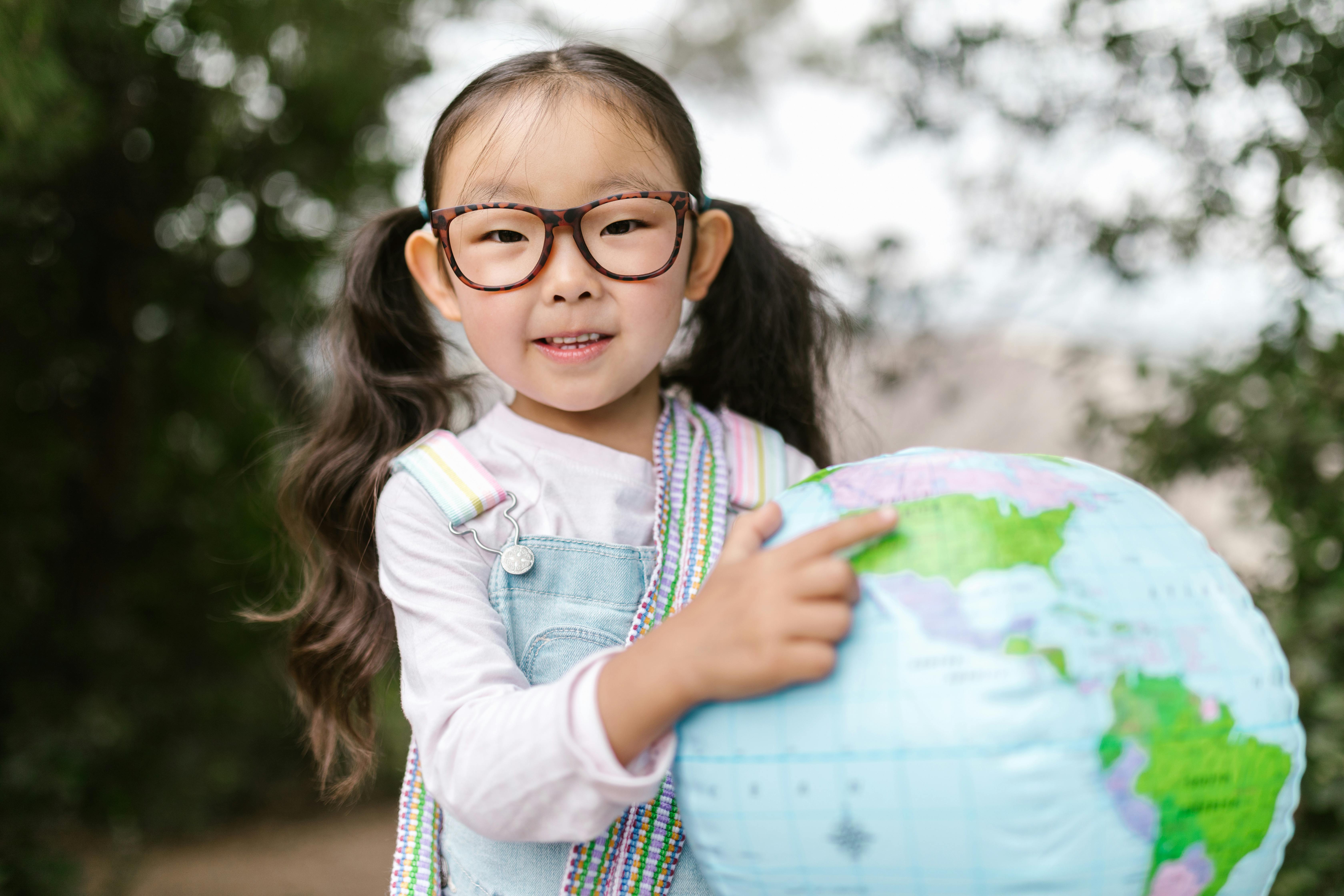 girl in blue and white long sleeve shirt wearing eyeglasses smiling