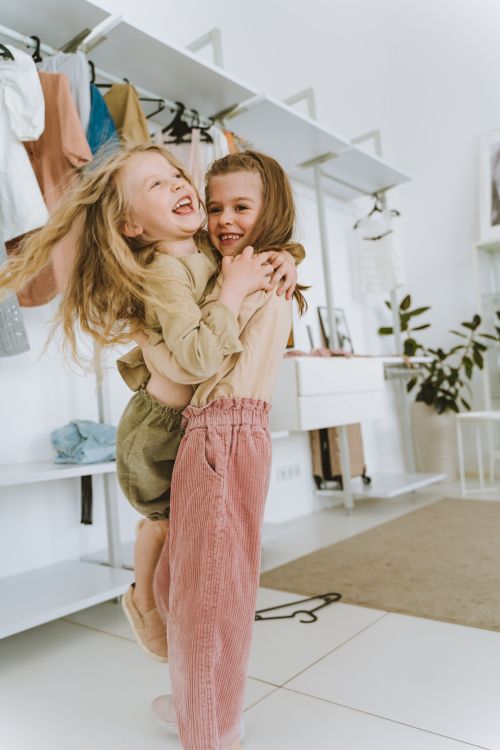 Free Two young girls share a joyful hug indoors, showcasing happiness and friendship. Stock Photo
