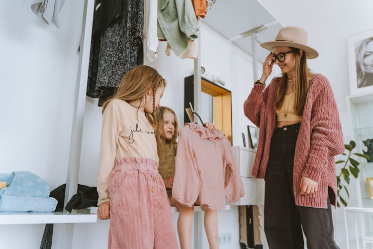 Photo Of A Girl Holding A Shirt Near Her Mom