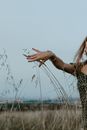 A Woman Touching Grass in the Wild