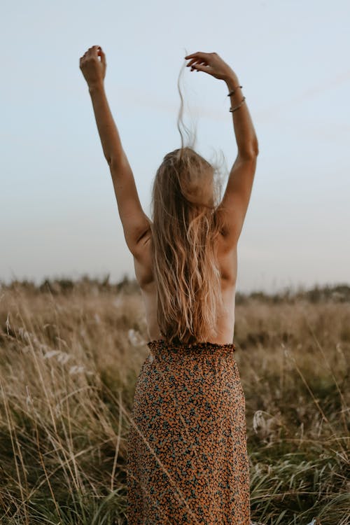 Woman with Long Hair Wearing Skirt Raising Her Hands Up