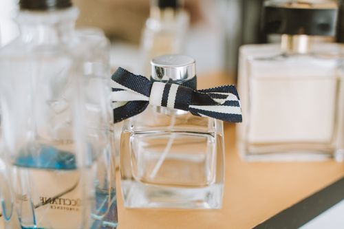 Free Close-up of elegant perfume bottles with focus on one with ribbon. Stock Photo