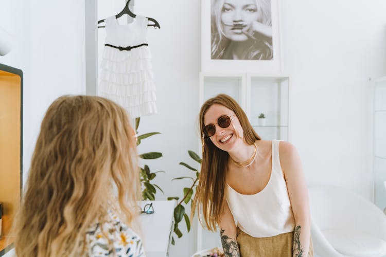 A Tattooed Mother Looking At Her Daughter