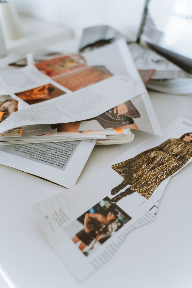 Torn magazine pages laid out on a desk — photo by Anastasia Shuraeva on Pexels