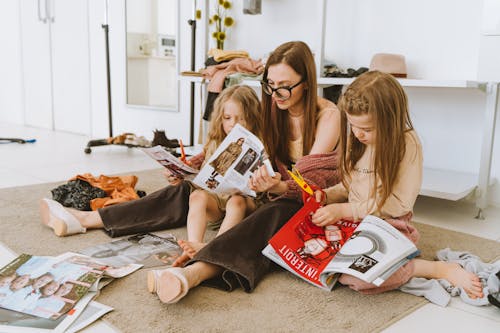 Girls Cutting Magazines with Their Mother