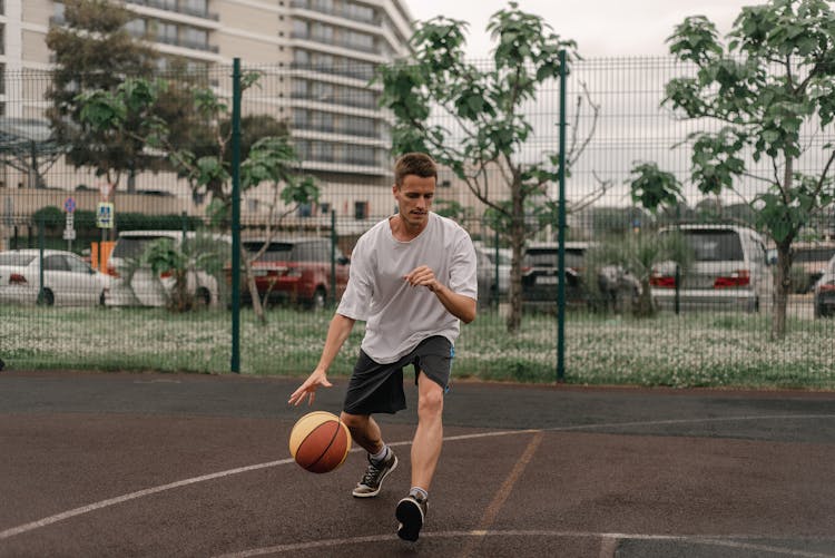 Man In White Shirt Playing Basketball