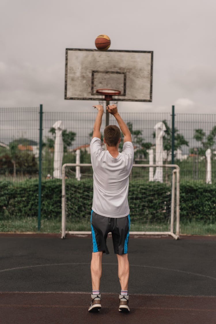 Man Shooting A Ball