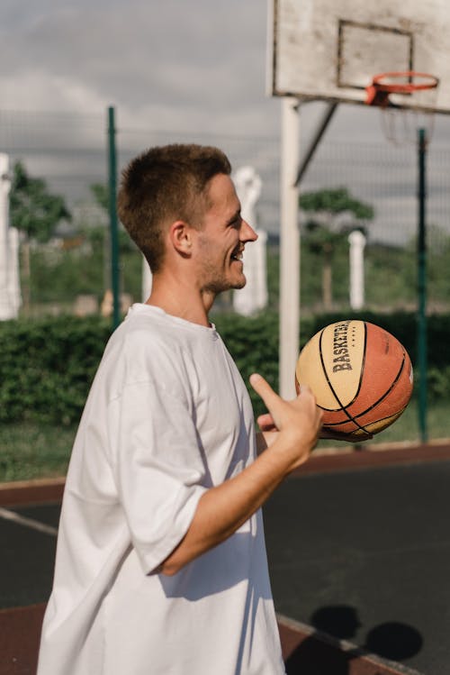 Free Man Holding a Ball at the Court Stock Photo