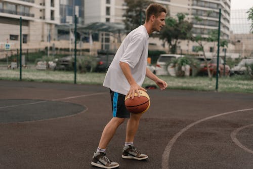 Free Person in White Shirt Playing Basketball Stock Photo
