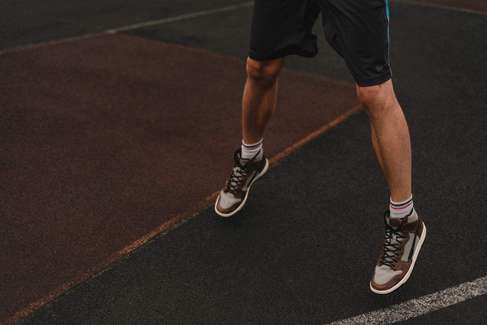 Person outdoors wearing athletic socks on a bright walking path