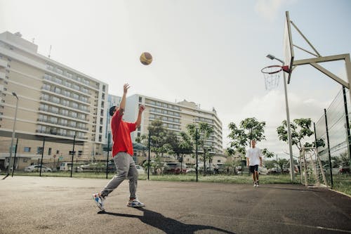 Free Men Playing Leisure Basketball in the Park Stock Photo