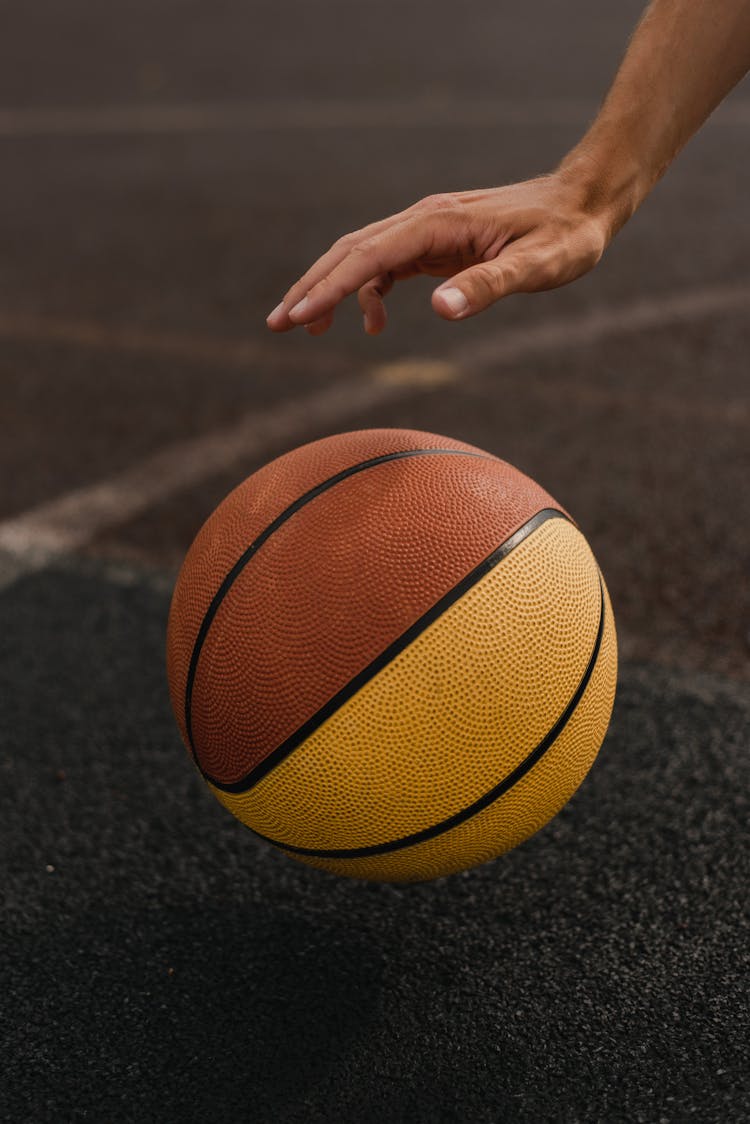 A Person Dribbling A Basketball