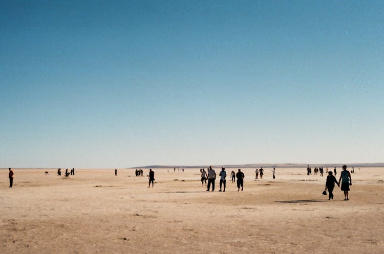 People Walking On Desert