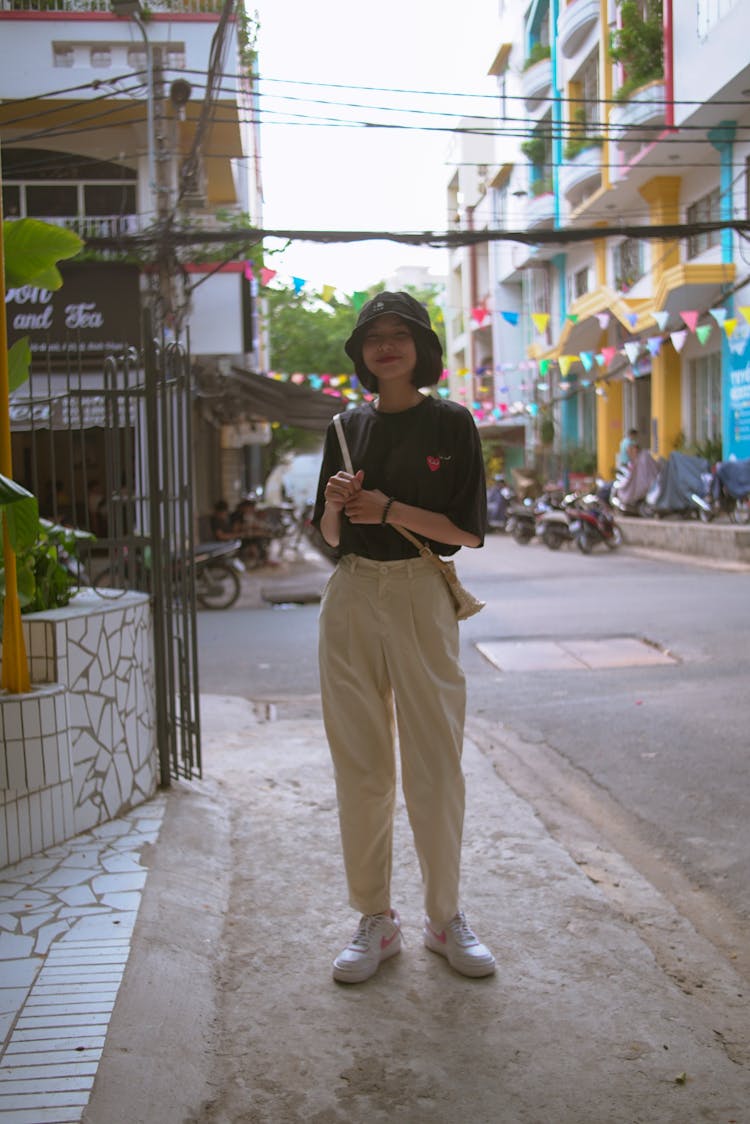 A Teenage Girl Standing On Sidewalk