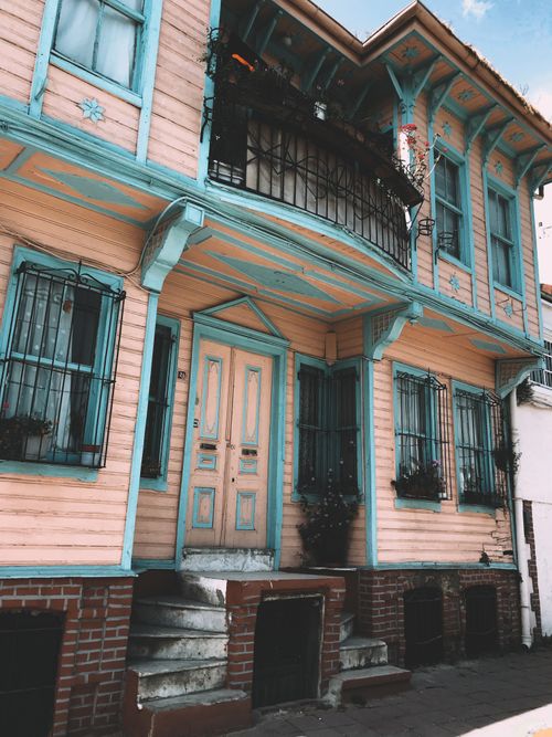 Free Charming Ottoman-style wooden house with vibrant turquoise trim in Fatih, Istanbul. Stock Photo