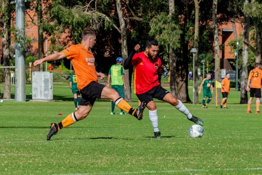 Action-packed soccer game with players competing fiercely on a bright green field.