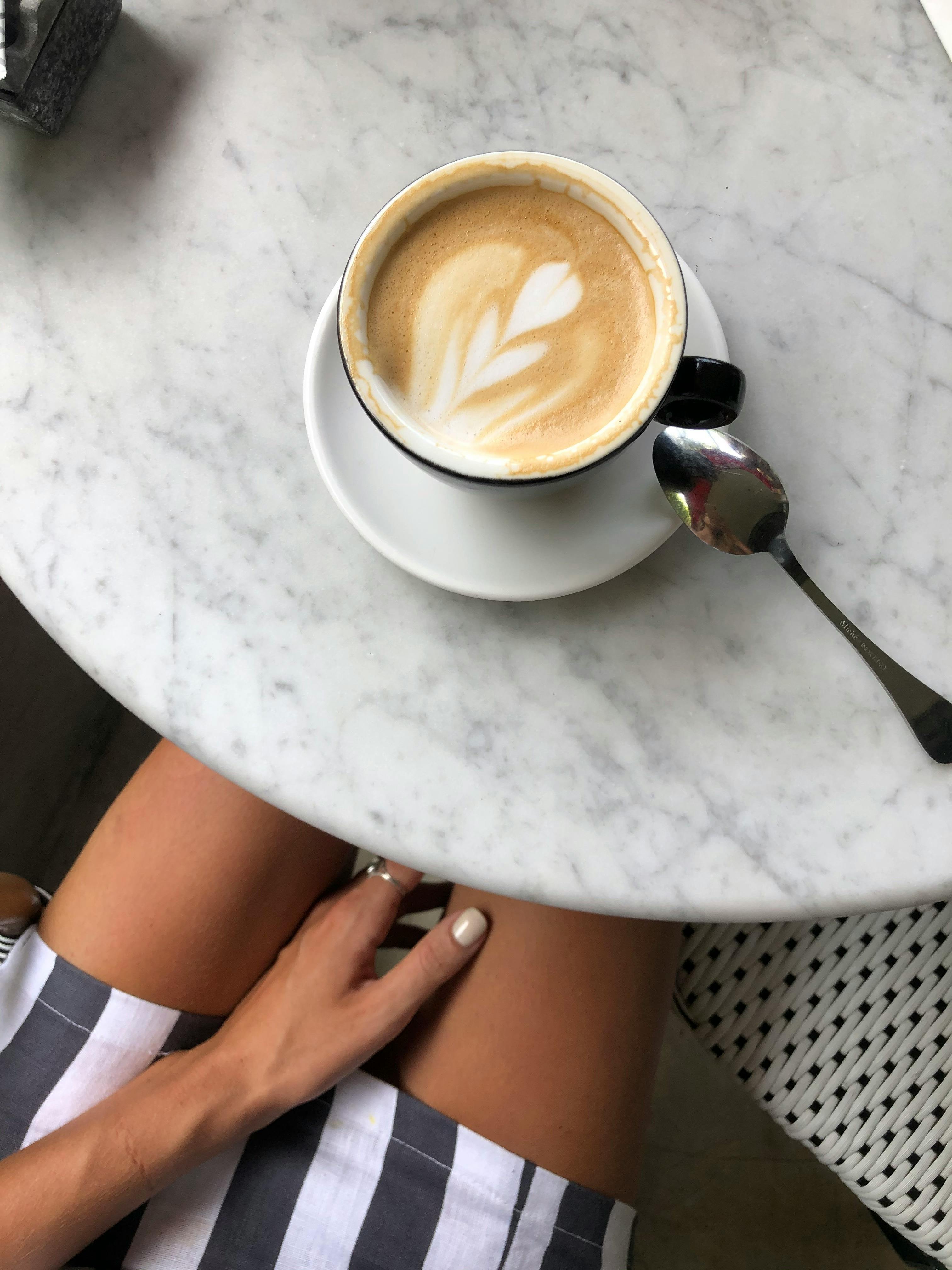 crop woman with cup of coffee in cafe