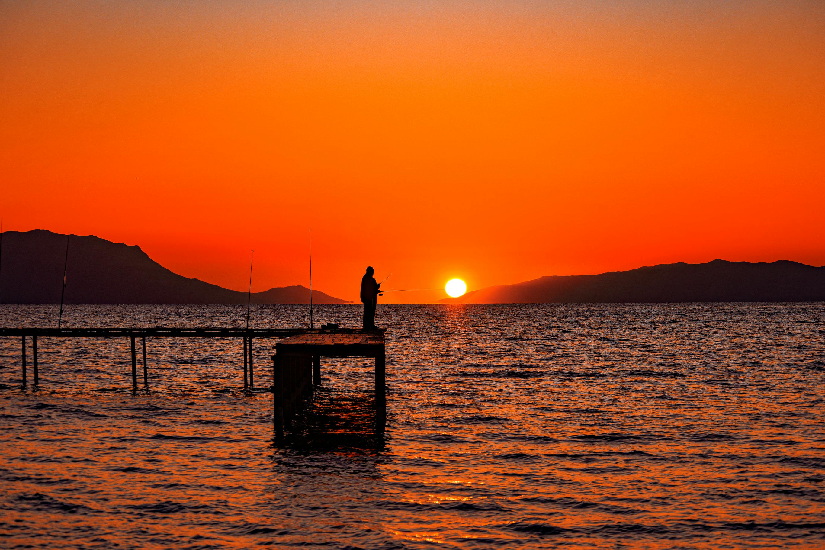 Man on Fishing Pier stock image. Image of sunset, harvey - 269720267