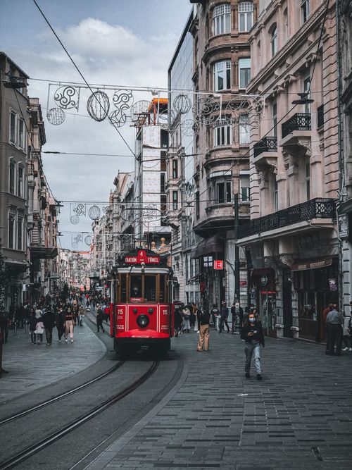 Free A vibrant scene featuring the historic red tram traversing a bustling street in Istanbul, Turkey. Stock Photo