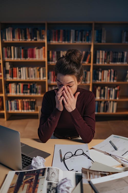 Free Tired Woman in the Library Stock Photo