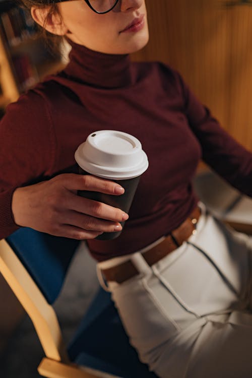 Free Person in Red Sweater Holding White Disposable Cup Stock Photo